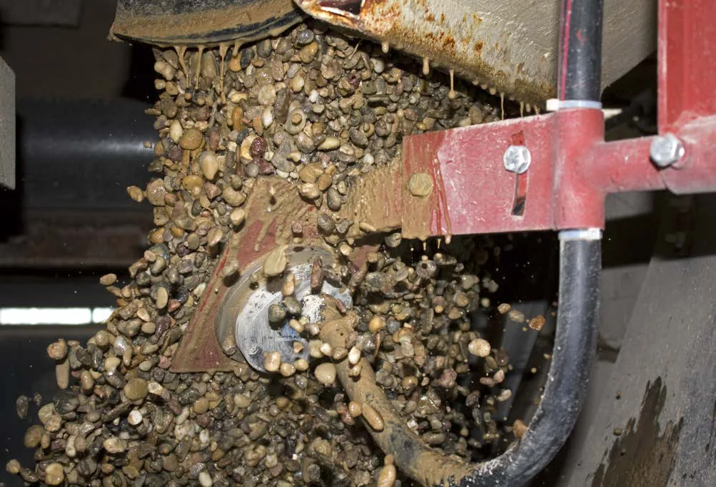 TDR moisture probe installed at a conveyor discharge measuring aggregate
