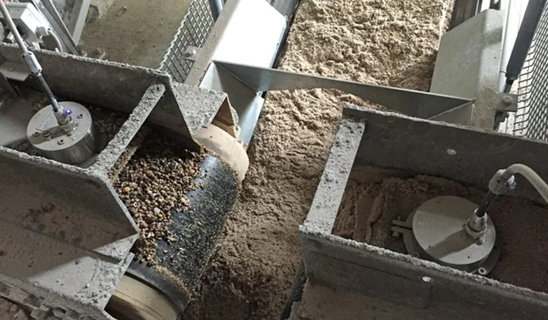 Two inline moisture sensors installed under bin gates with aggregate discharging